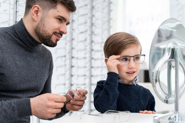 little-boy-father-store-trying-glasses little-boy-father-store-trying-glasses